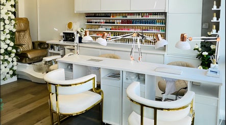 Chic nail studio in DollhouseClawz, Poole, England, GB with sleek chairs and vibrant polish display.