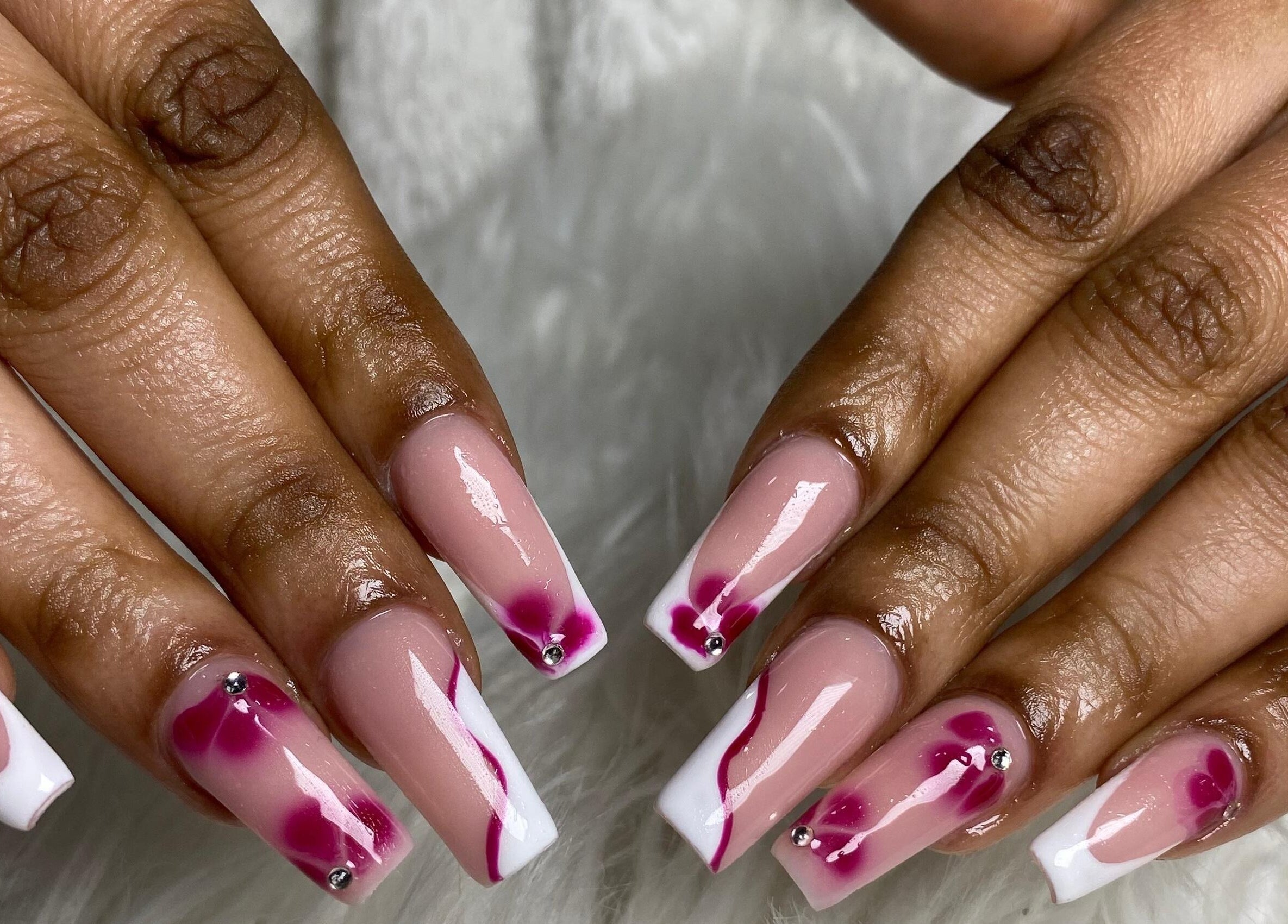 Floral nail design at Naileen Beauty, Midrand, Gauteng, ZA showcasing intricate pink and white patterns.