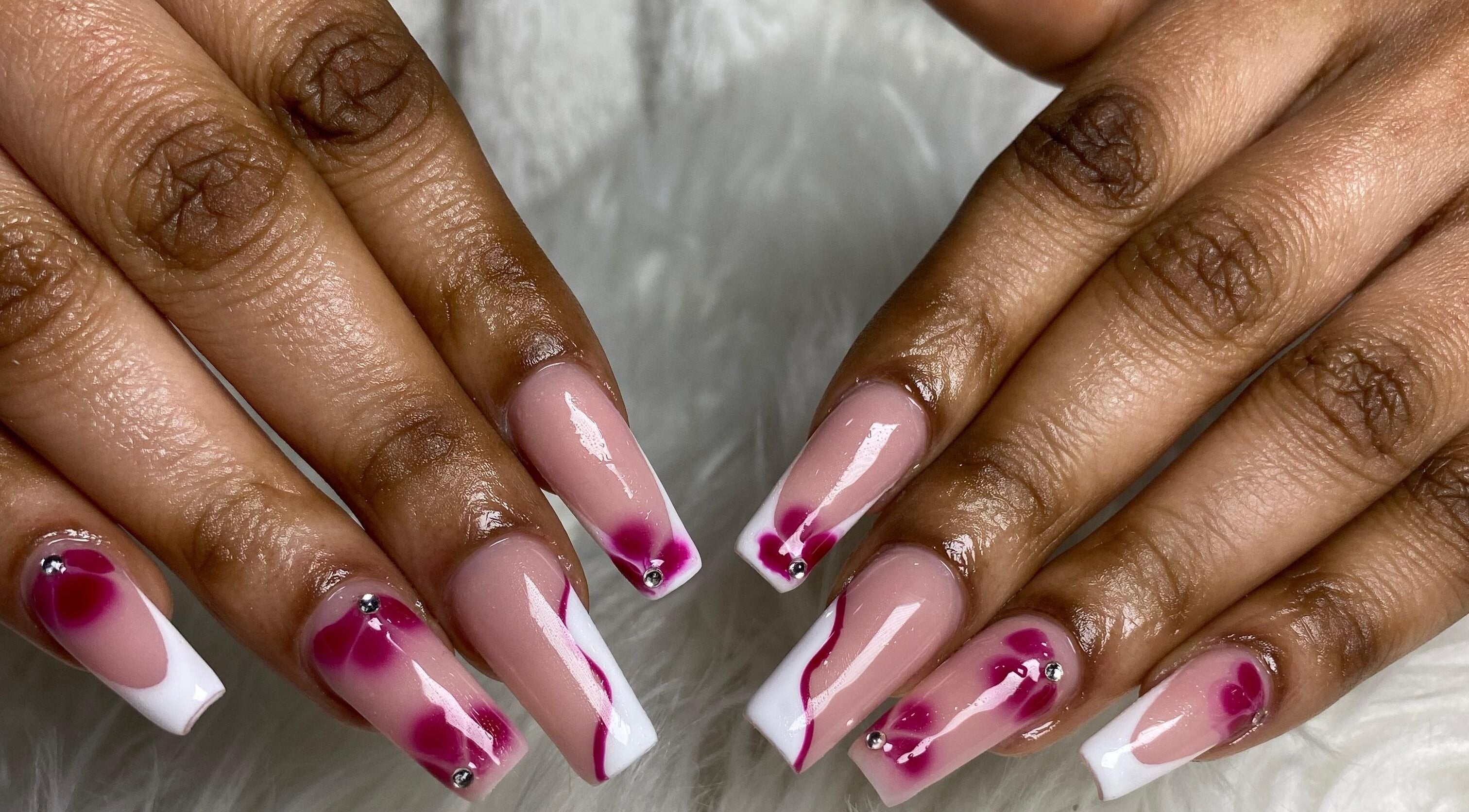 Floral nail design at Naileen Beauty, Midrand, Gauteng, ZA showcasing intricate pink and white patterns.