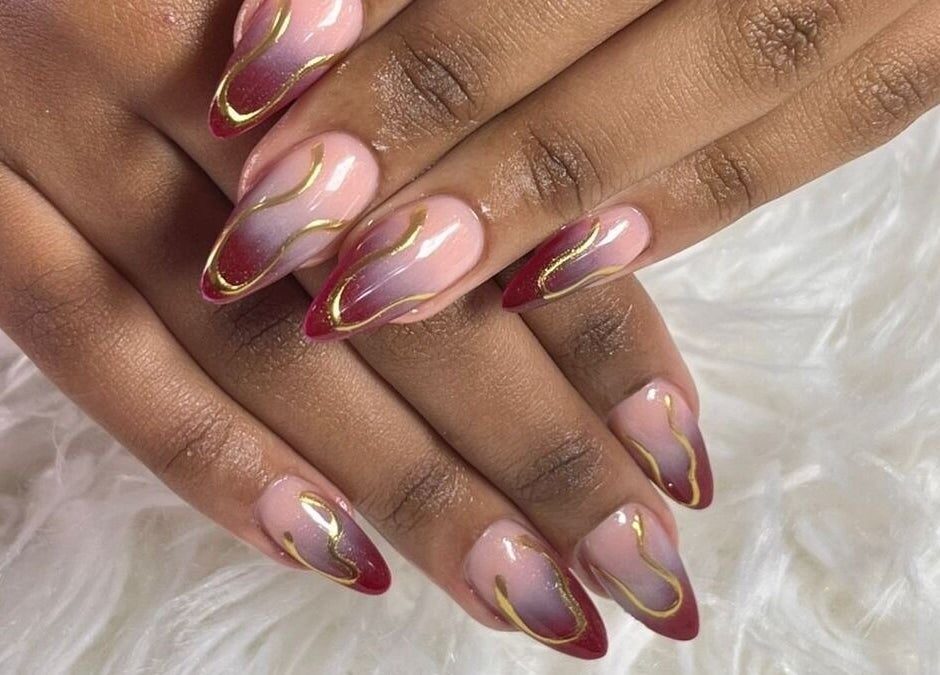 Elegant nail design with red and gold accents at Naileen Beauty, Midrand, Gauteng, ZA.