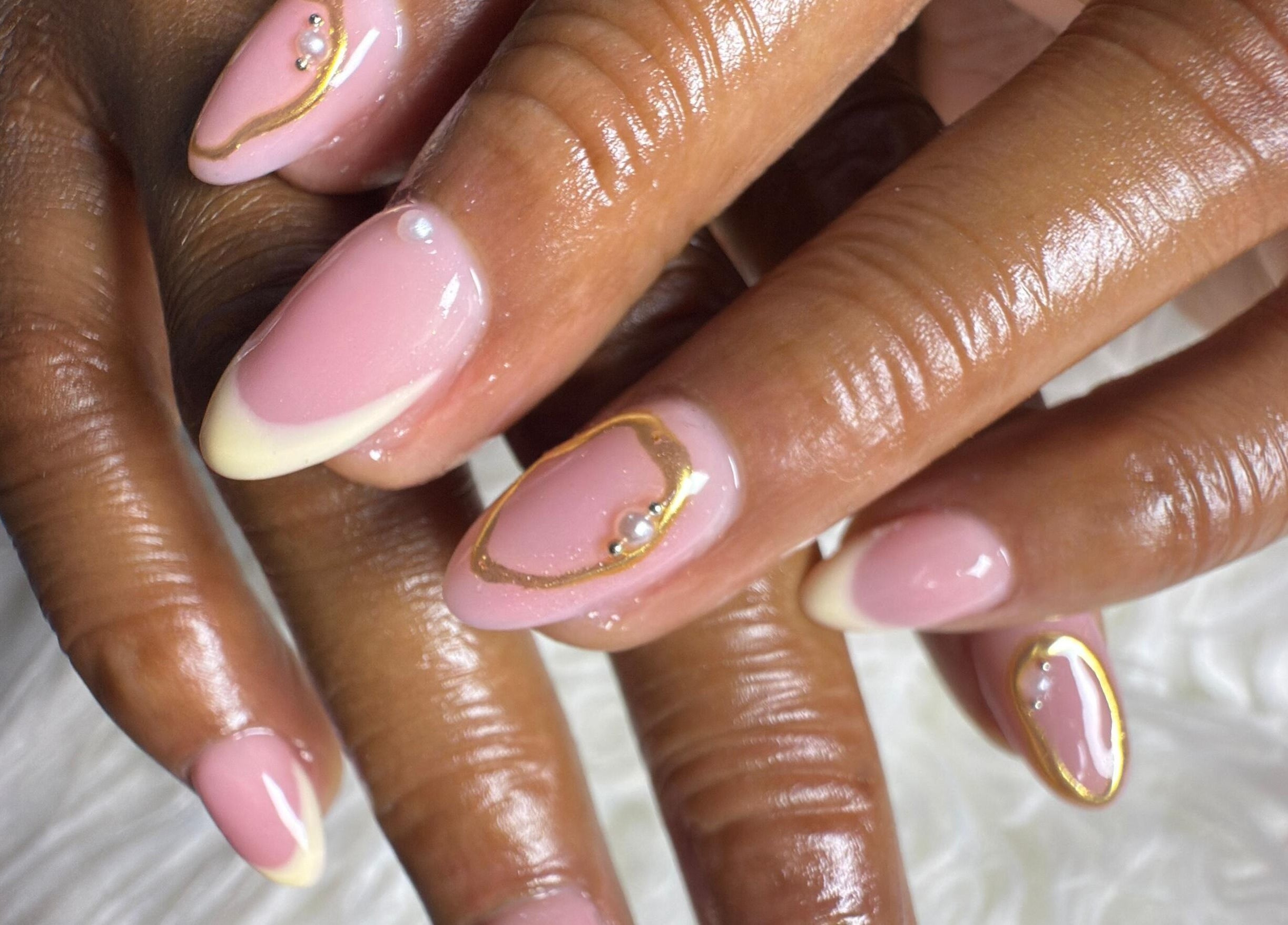 Elegant manicured nails with pink and gold design at Naileen Beauty, Midrand, Gauteng, ZA.