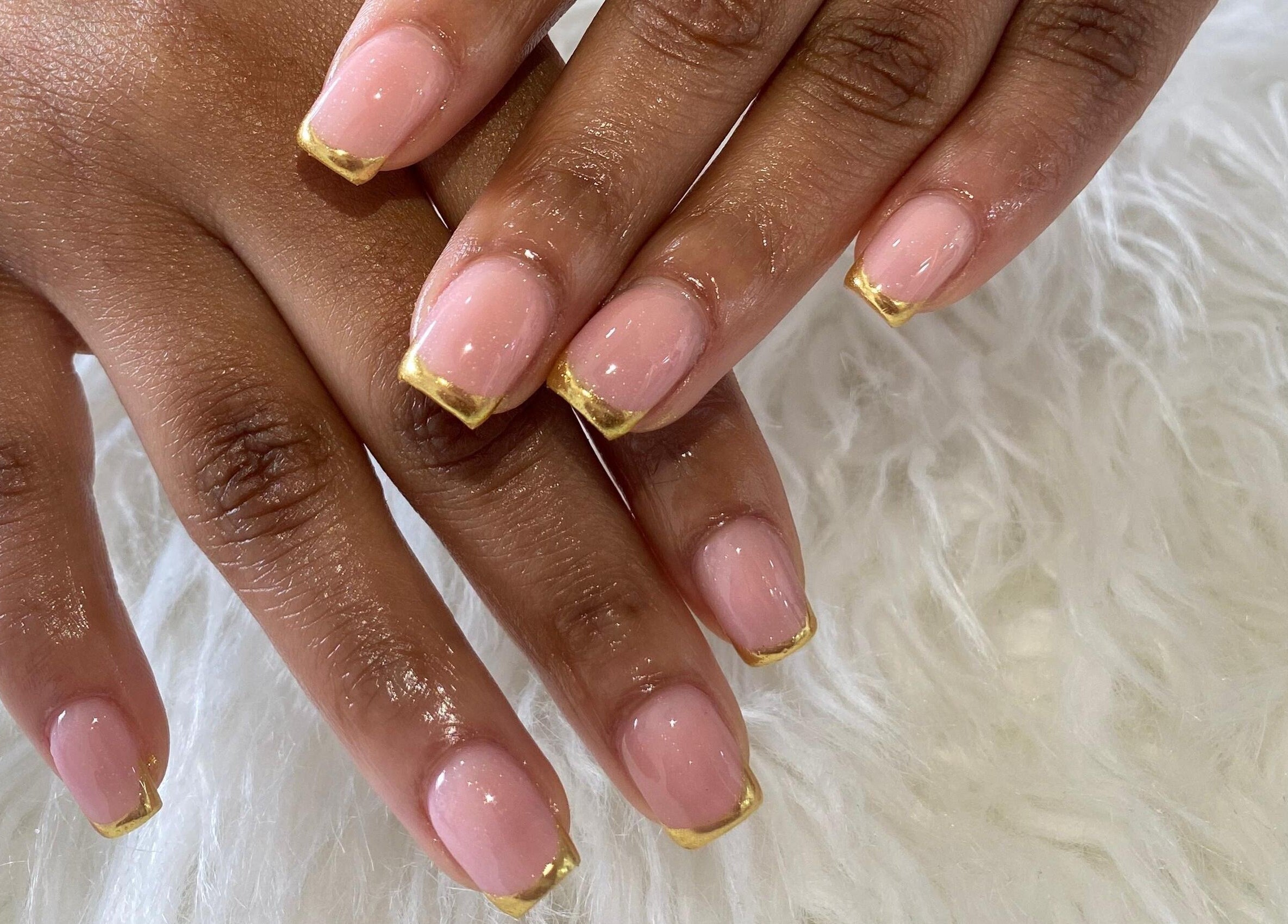 Elegant gold-tipped nails at Naileen Beauty in Midrand, Gauteng, ZA, showcasing intricate manicure design.