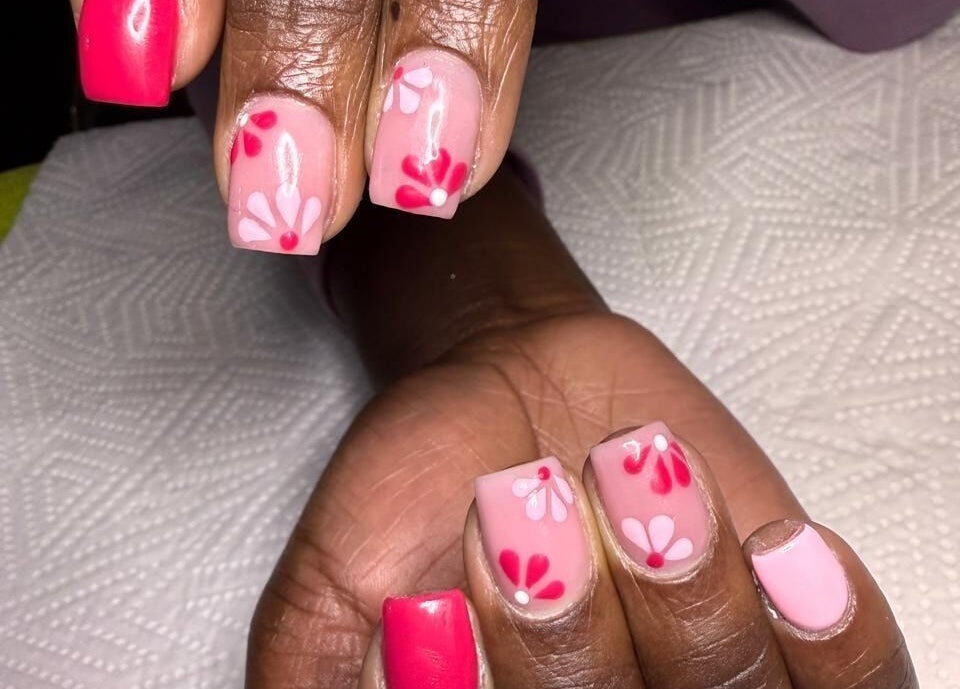 Floral pink nail art at Naileen Beauty in Midrand, Gauteng, ZA, showcasing elegant design.