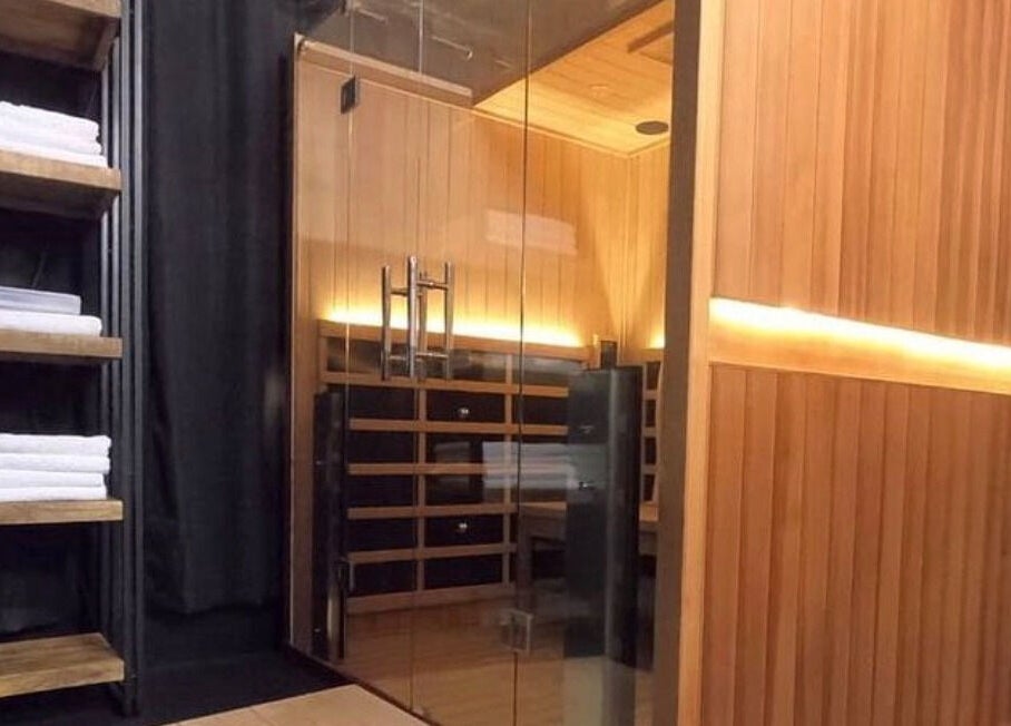 Luxurious sauna at Bare Bronze Skin Clinic, Strathdale, Victoria, AU, with neatly stacked towels.