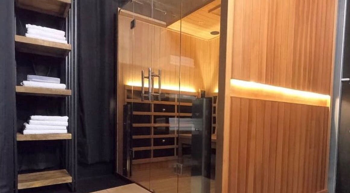 Luxurious sauna at Bare Bronze Skin Clinic, Strathdale, Victoria, AU, with neatly stacked towels.
