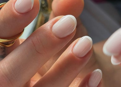 Close-up of elegant French manicure at Auric Alchemy Nails, Northampton, England, GB. Perfectly polished nails.