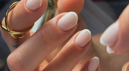 Close-up of elegant French manicure at Auric Alchemy Nails, Northampton, England, GB. Perfectly polished nails.