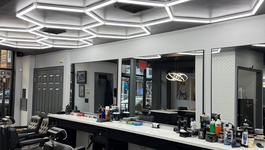 Modern interior of Benny & Bina’s salon, Dobbs Ferry, New York, US with sleek barber chairs and bright lighting.