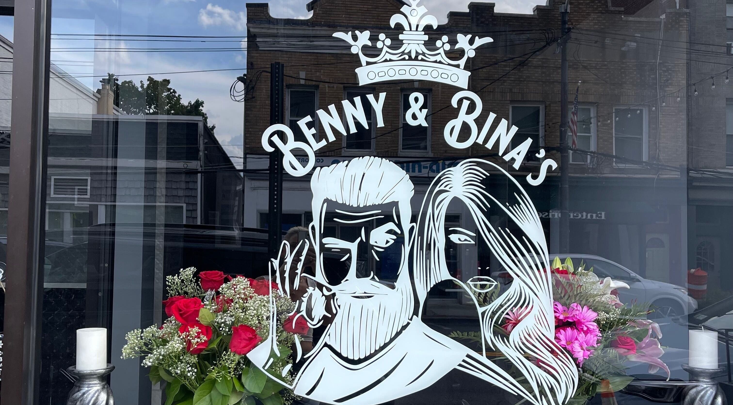 Benny & Bina’s storefront sign with floral display in Dobbs Ferry, New York, US.