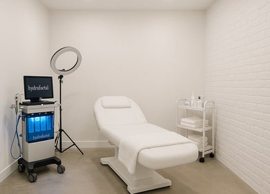 Elegant spa room at bioskinconcept in Toronto, Ontario, CA featuring a modern treatment bed and hydrafacial equipment.