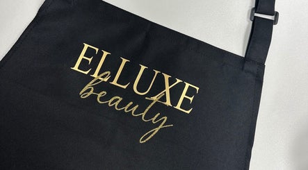 Elluxe Beauty apron with gold logo, highlighting elegance at Leigh, England, GB.