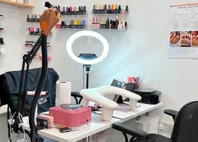 Inside Nailed by Alori, Luton, England, GB with elegant nail polish displays and a modern workspace.