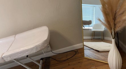 Sims Beauty treatment room in Oundle, England, GB with a stylish mirror and massage table.