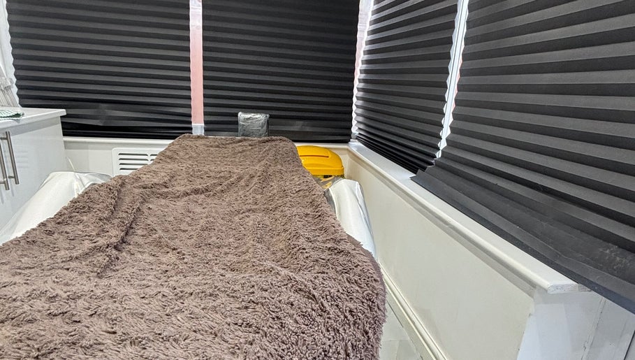 Comfortable treatment bed at Sims Beauty in Stilton, England, GB, ready for a relaxing wellness experience.