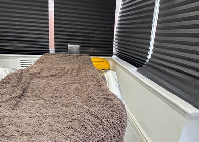 Comfortable treatment bed at Sims Beauty in Stilton, England, GB, ready for a relaxing wellness experience.