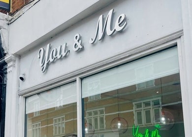 Exterior view of Micro Glow PMU, a beauty venue in London, England, GB, showing elegant signage.