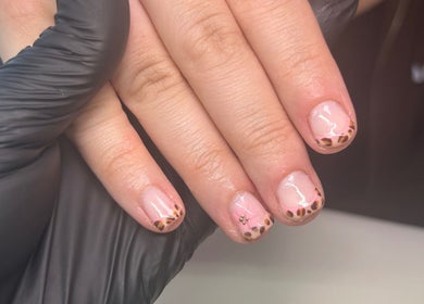 Elegant nail art design at Beautbynatz, Bathgate, Scotland, GB, showcasing leopard print tips.