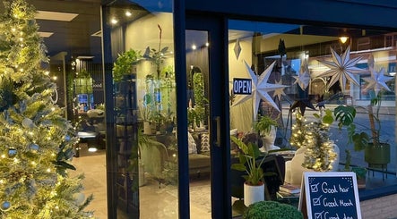 Festive decor at Hair by Erin, Mildenhall, England, GB, with glowing lights and plants creating a cozy atmosphere.