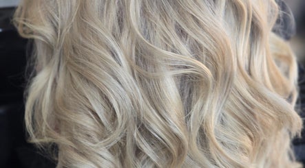 Blonde wavy hair styled at Dreamcuts and Styles, Fulshear, Texas, US, showcasing elegant curls.