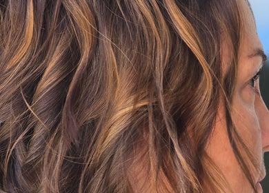 Close-up of styled wavy brown hair at Dreamcuts and Styles, Fulshear, Texas, US.
