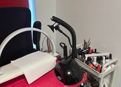 Elegant nail station at NailsbyAsher in Coventry, England, GB with tools and polish for manicures.