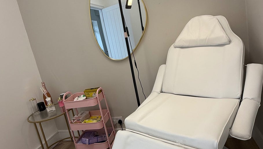 Elegant treatment room at Dollz Aesthetics NE, Hebburn, England, GB with a plush chair and beauty essentials.