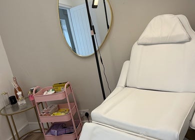 Elegant treatment room at Dollz Aesthetics NE, Hebburn, England, GB with a plush chair and beauty essentials.