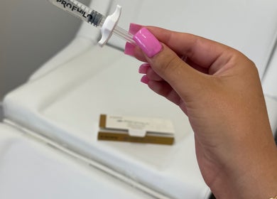 Hand holding a beauty treatment syringe at Dollz Aesthetics NE, Hebburn, England, GB.