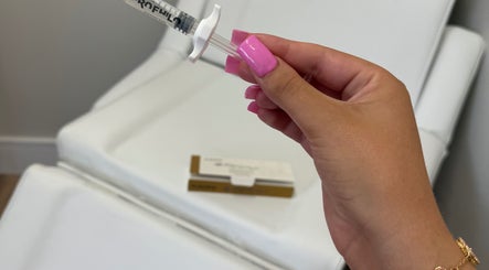 Hand holding a beauty treatment syringe at Dollz Aesthetics NE, Hebburn, England, GB.