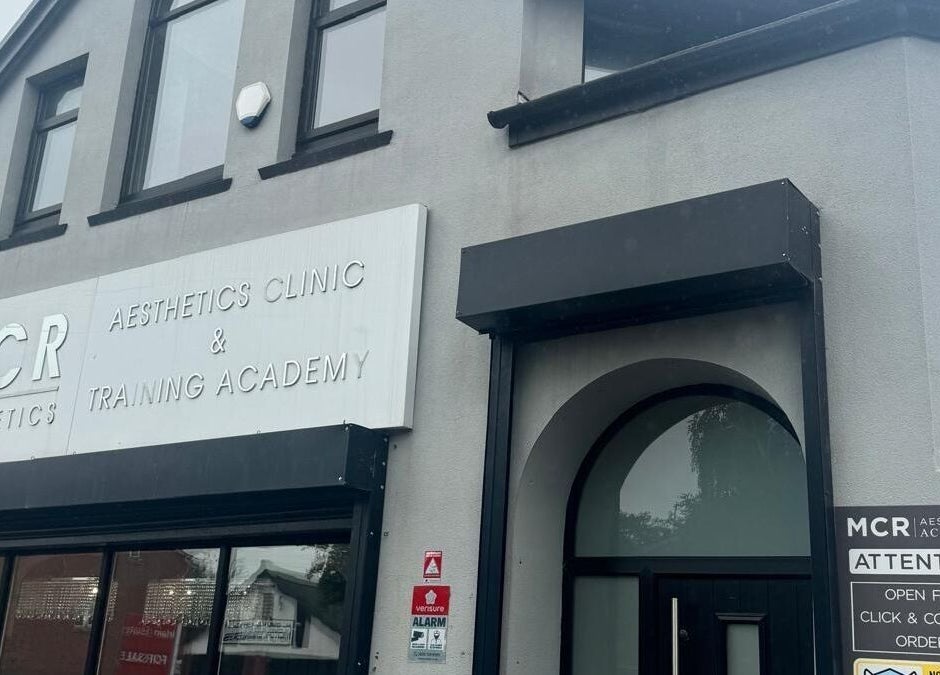 Entrance of MCR Medispa, Worsley, England, GB, showcasing modern aesthetics in a sleek building front.
