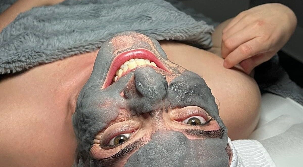 Client enjoying a clay facial mask at Lini's Cosmetics, Vaughan, Ontario, CA.