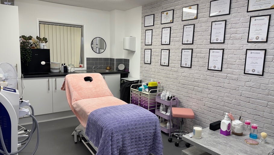 Inviting beauty treatment room at FTC, Ipswich, England, GB with certificates and cozy setup.