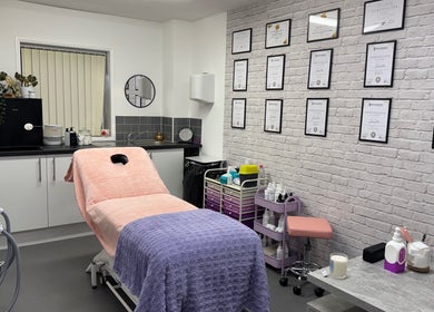 Inviting beauty treatment room at FTC, Ipswich, England, GB with certificates and cozy setup.
