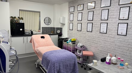 Inviting beauty treatment room at FTC, Ipswich, England, GB with certificates and cozy setup.