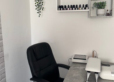 FTC nail station in Ipswich, England, GB featuring organized shelves and a sleek black chair.