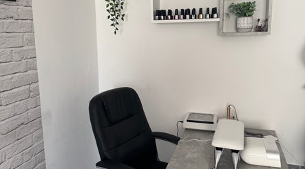 FTC nail station in Ipswich, England, GB featuring organized shelves and a sleek black chair.