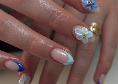 Elegant floral nail art at RB BEAUTY THERAPY, Glasgow, Scotland, GB. Featuring intricate blue flower designs.