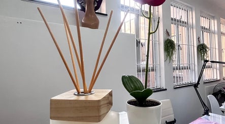 Relaxing diffuser and potted plant at Nocky Designs, Durban, Kwazulu-natal, ZA enhancing a tranquil ambience.
