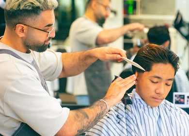 Barber expertly trims hair at Modern Man Barbershop, located in Christchurch, Canterbury Region, NZ.