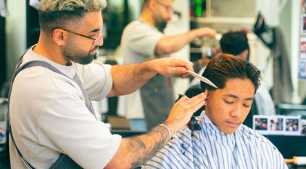 Barber expertly trims hair at Modern Man Barbershop, located in Christchurch, Canterbury Region, NZ.