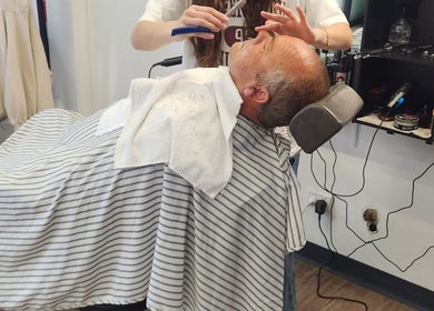 Client enjoys a classic shave at Modern Man Barbershop, Christchurch, Canterbury Region, NZ.
