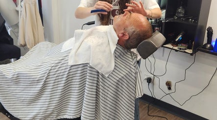 Client enjoys a classic shave at Modern Man Barbershop, Christchurch, Canterbury Region, NZ.