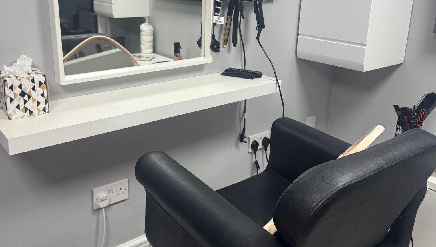 Modern salon chair and styling station at Mila Hair Atelier, Epsom, England, GB.