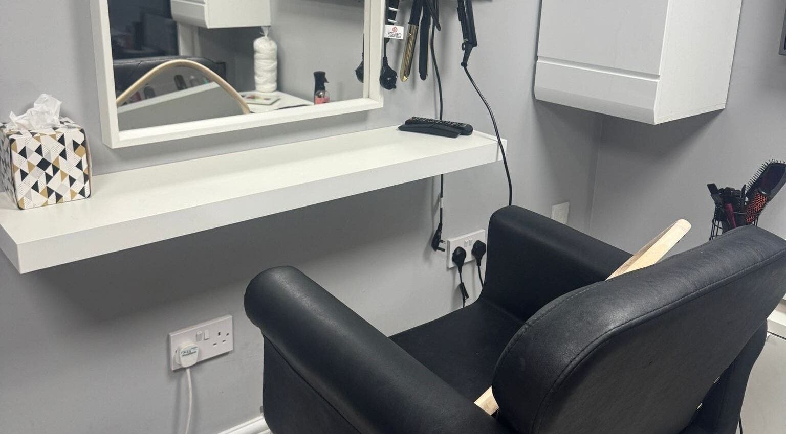 Modern salon chair and styling station at Mila Hair Atelier, Epsom, England, GB.