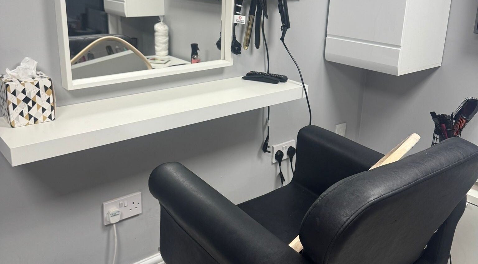 Modern salon chair and styling station at Mila Hair Atelier, Epsom, England, GB.