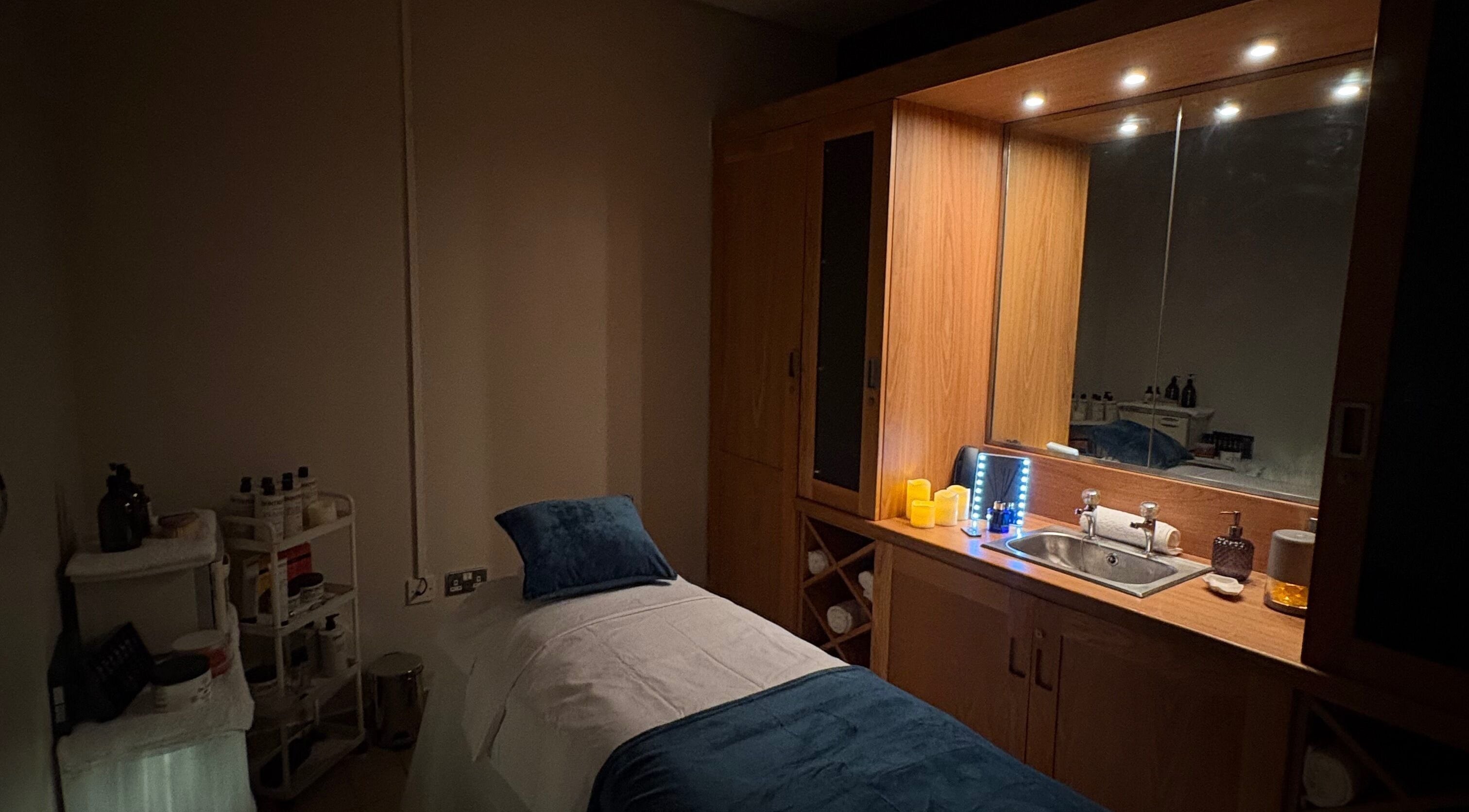 Cozy treatment room at Bay Sanctuary in Swansea, Wales, GB, featuring a massage bed and ambient lighting.