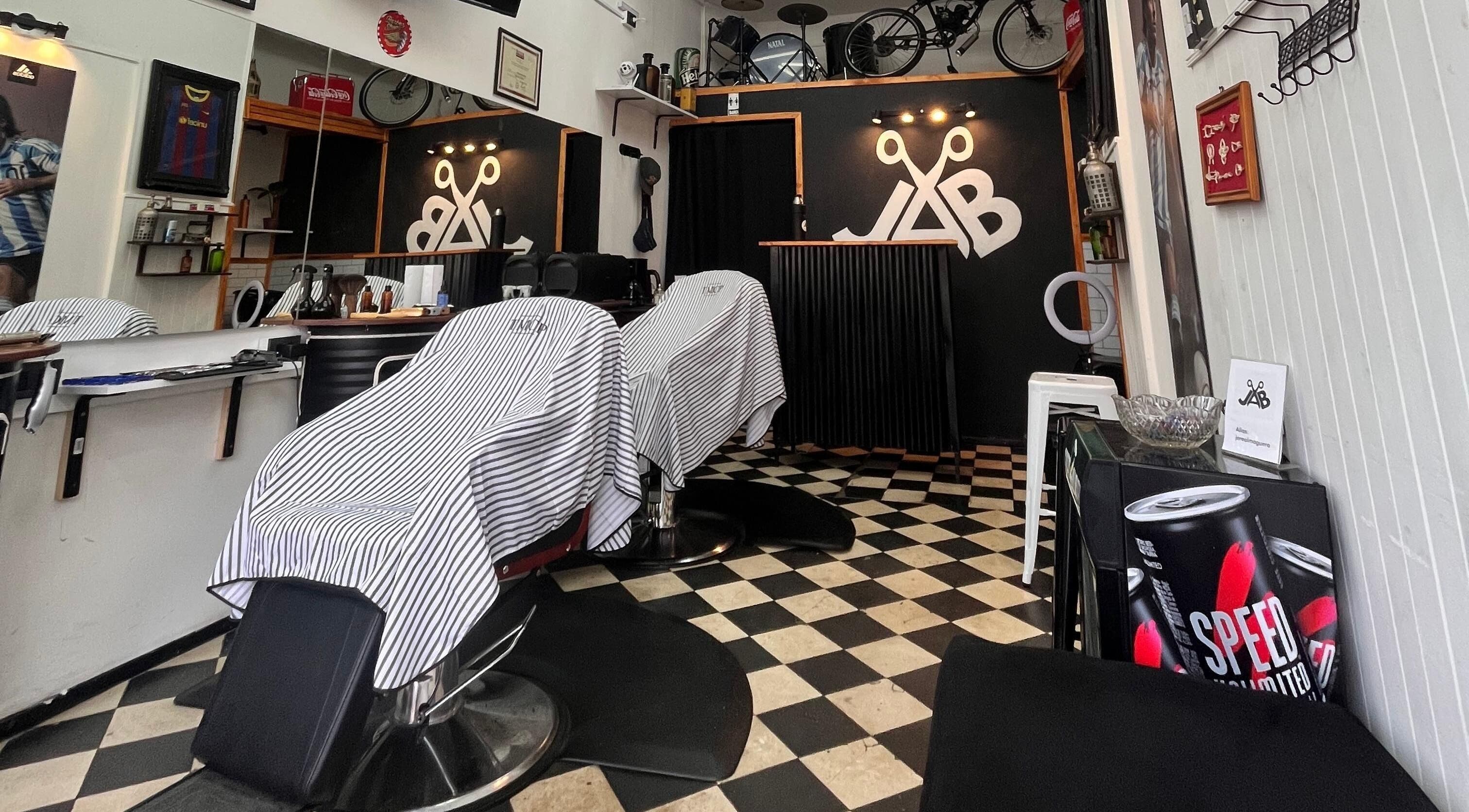 Interior moderno de Jab Barber en Rosario, Santa Fe, AR, mostrando sillas de barbería y decoración elegante.