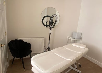 Calm treatment room at Ocean Head & Body Spa | By Kait | Chester, England, GB with plush chair and massage table.