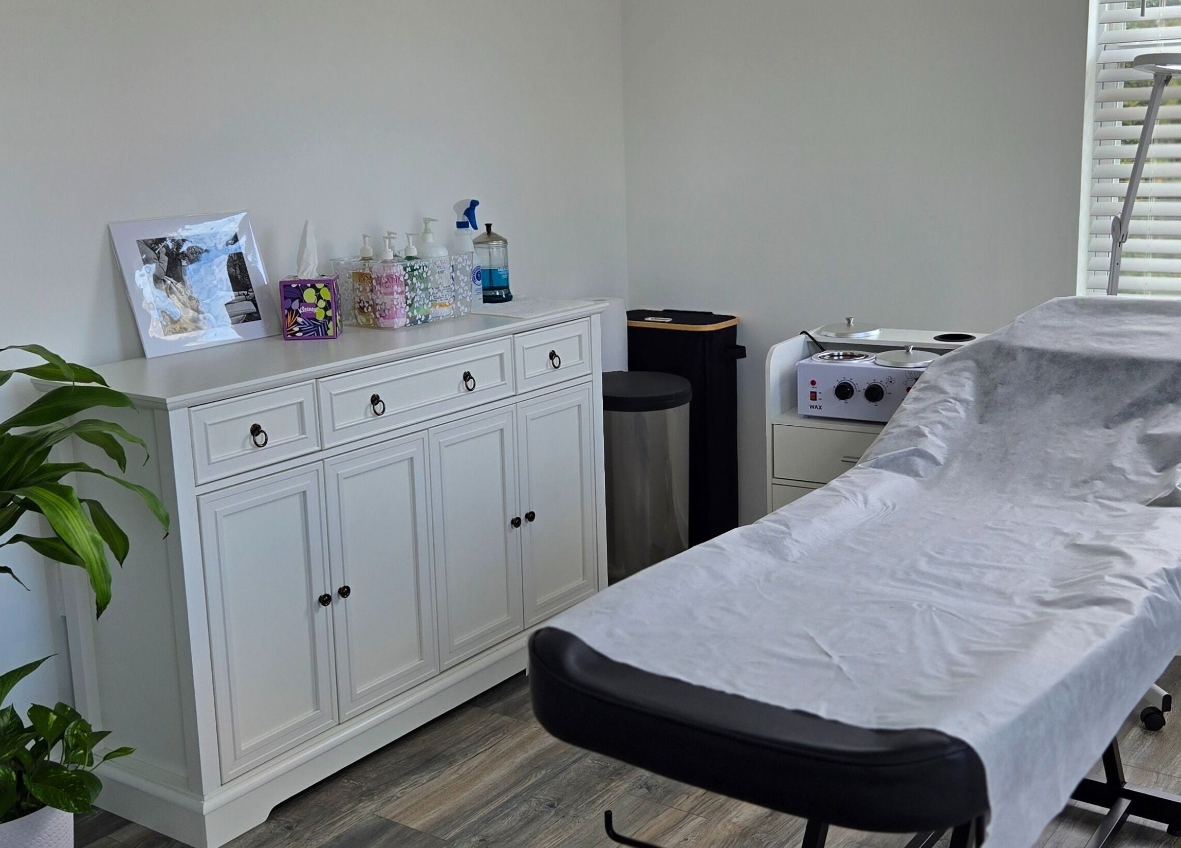 Cozy treatment room at Four Seasons Beauty Salon, Doylestown, Pennsylvania, US with massage bed and essentials.
