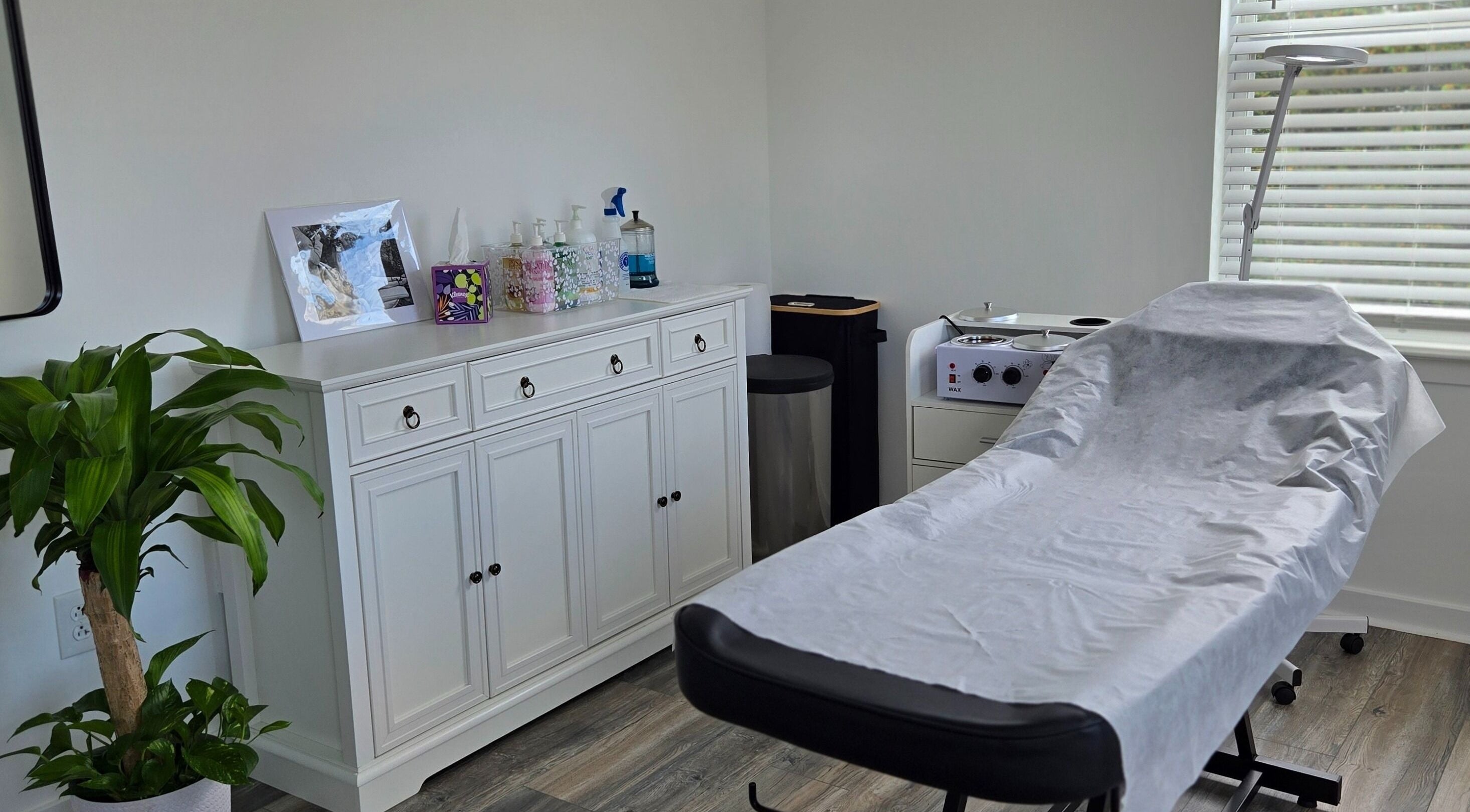 Cozy treatment room at Four Seasons Beauty Salon, Doylestown, Pennsylvania, US with massage bed and essentials.
